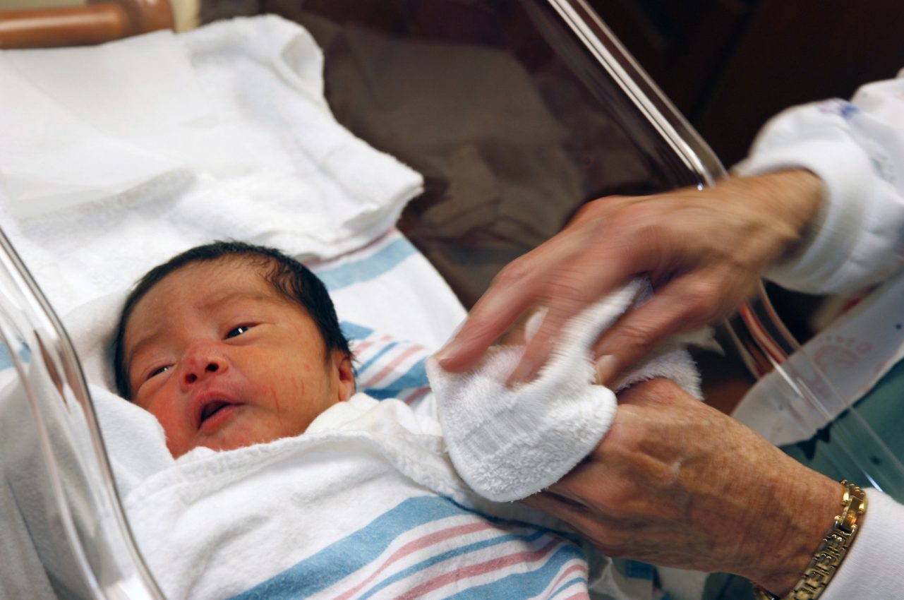 A newborn infant in a baby bassinet.  AnMed Health, Anderson, S.C. MedVerse - Hablamos Juntos