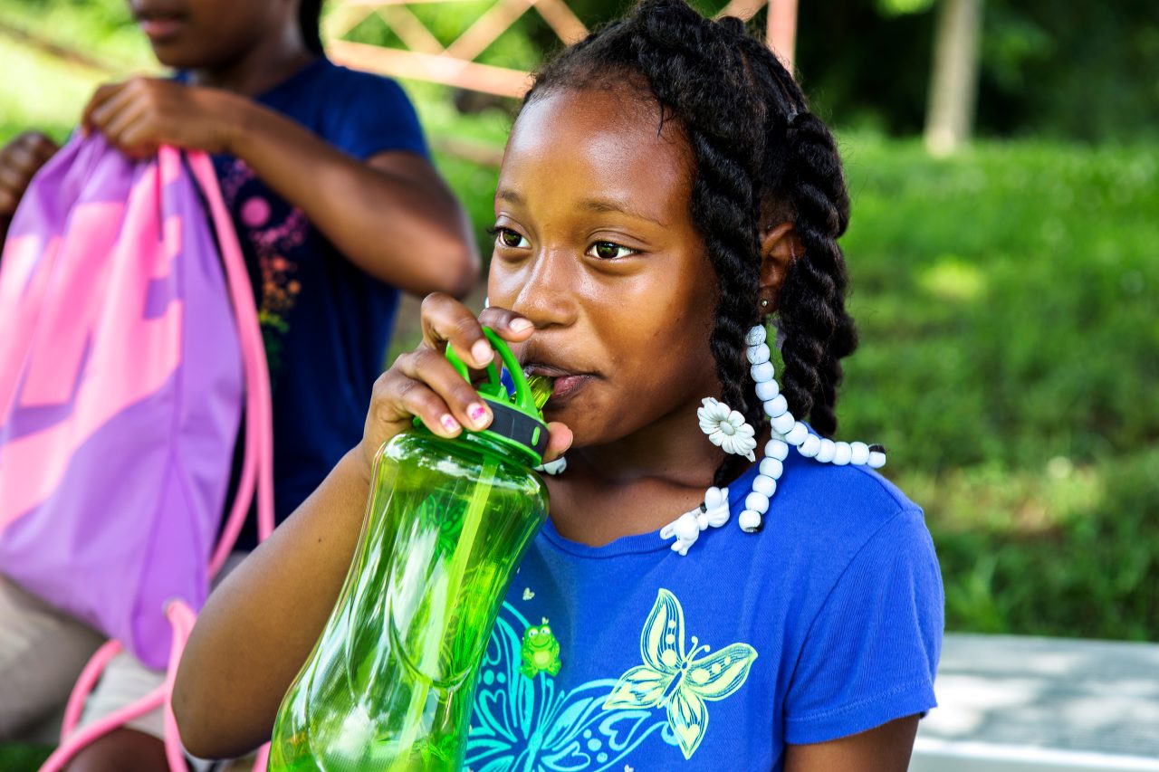 A girl drinks water after participating in the Boys & Girls Club summer camp in Oxford, North Carolina. Granville and Vance Counties, N.C.: Signs of Progress Toward Reversing the Childhood Obesity EpidemicCounties report declines in obesity among youths ages 2-18.